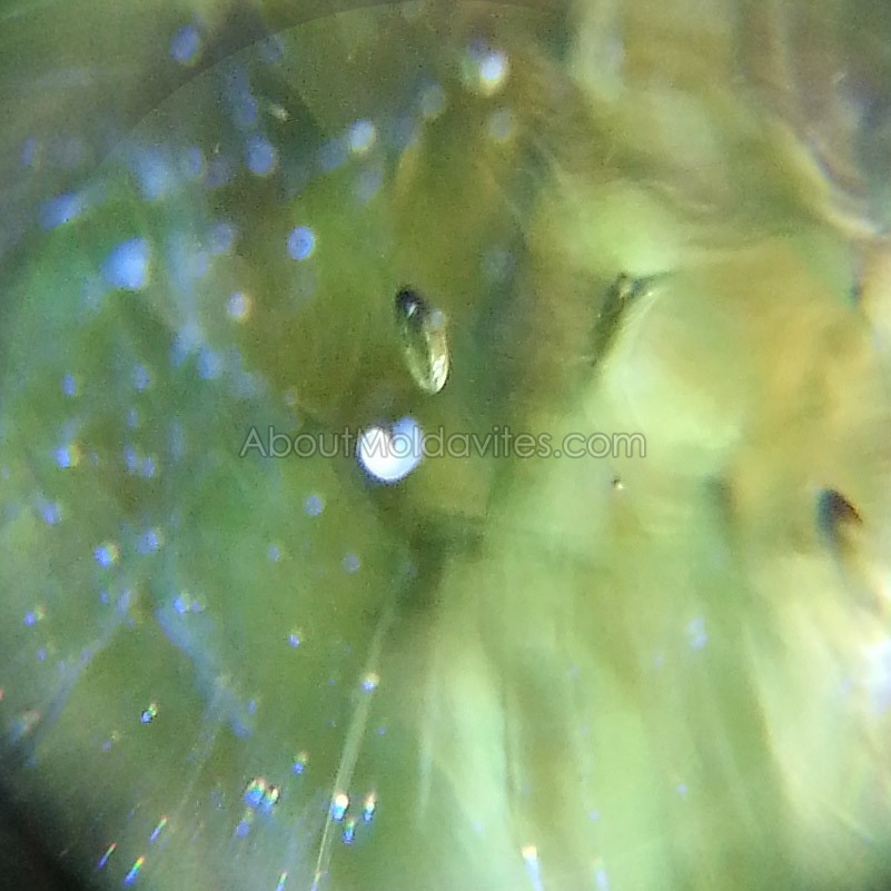 Small oblong bubble in damaged moldavite