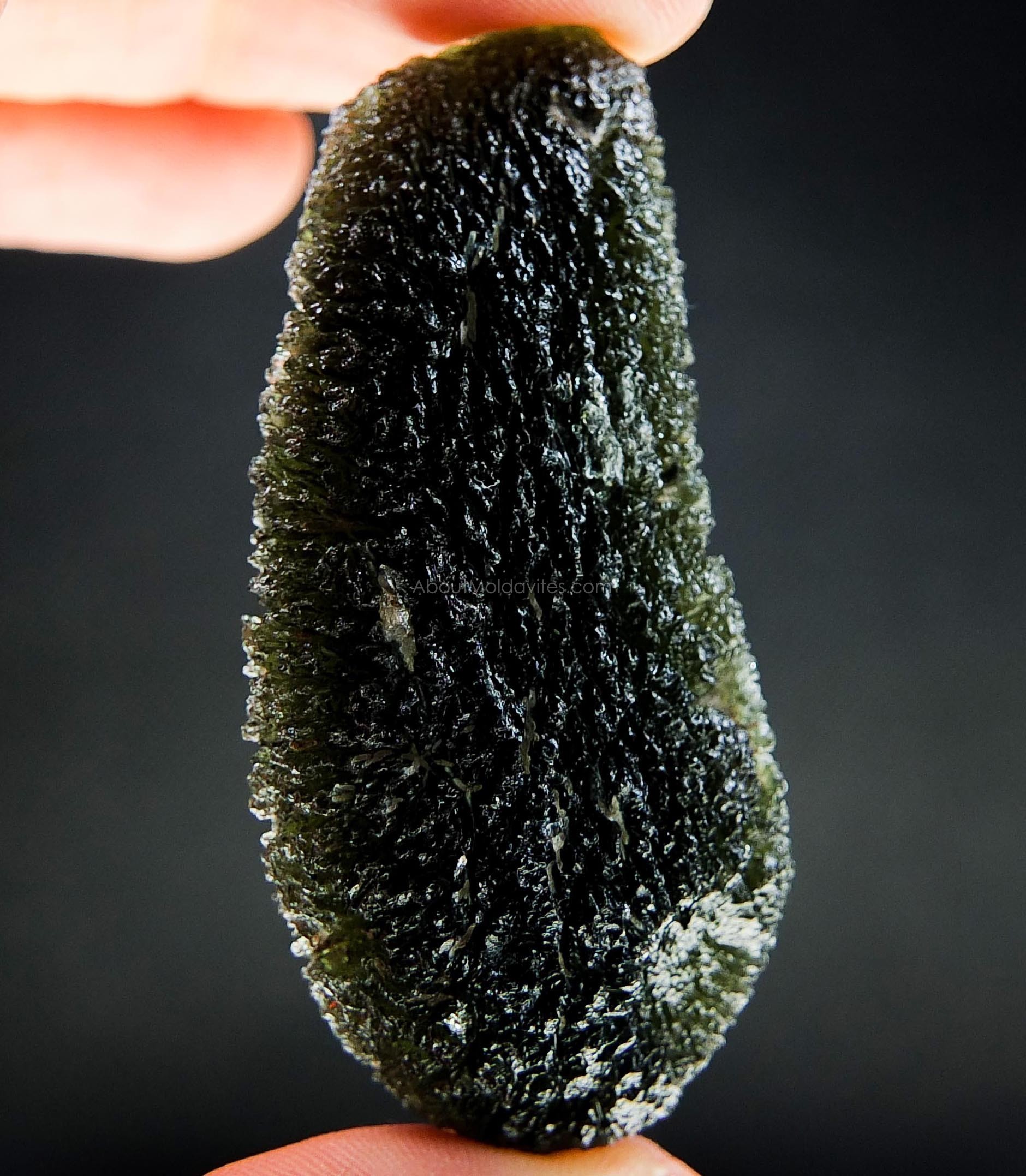 A moldavite with an unusual kind of damage