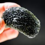 A moldavite with an unusual kind of damage